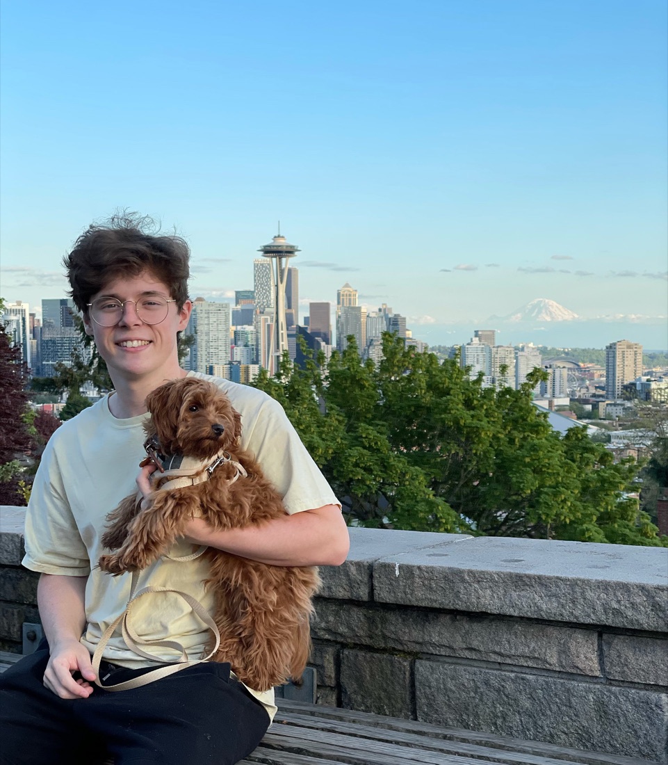 Braden Miller with his dog, Novo, overlooking the Seattle skyline